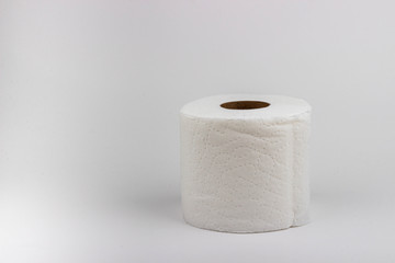 A high-key photograph of a roll of toilet paper.
