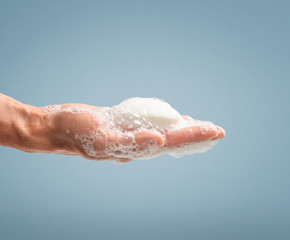 MAn holding a bar of soap