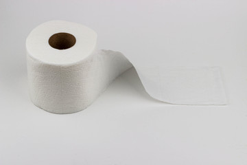 A high-key photograph of a white roll of toilet paper.