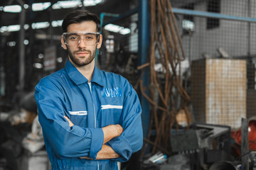 portrait image engineer men wearing uniform safety in factory background.