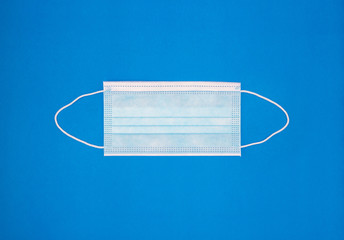 Ear-loop face mask 3 ply, Safety masks on blue background.Medical mask for protection against flu and other diseases and prevention of the spread of virus and epidemic.