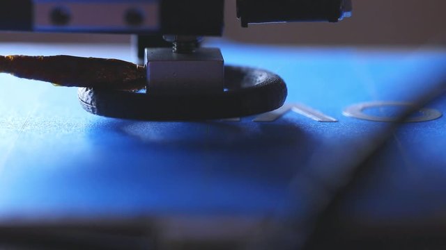 Slow motion of a 3D printer printing COVID19 words.