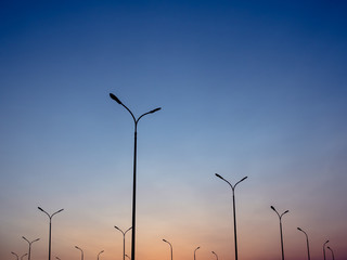 Modern green environment friendly street lamps in the sunset. Beautiful example of how modern architecture merges with the environment. Perfect for electrification or modern industrial design projects