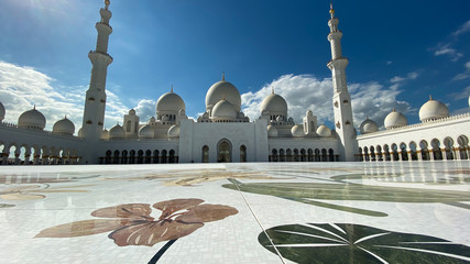 The Sheik Zahed Grand Mosque in Abu Dhabi with a beautiful women in front