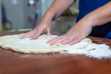 Close up of woman's hands making dough for homemade bread