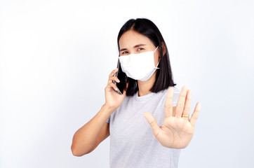 Beatiful asian woman portrait wearing mask and show stop hands gesture for Covid 19 or coronavirus