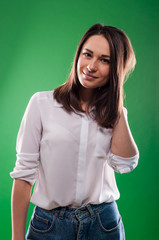 Pretty happy young girl is smiling and touching her hair