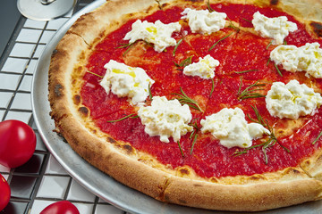 Classic margarita pizza with cream cheese or feta, tomatoes and basil. Italian pizza in a composition with ingredients on a white background. Top view. Food flat lay