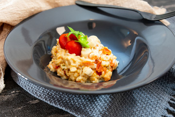 Tasty risotto with Shrimp, fresh herbs vegetables on a white plate