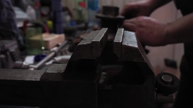 large metal long vice in the auto shop, auto mechanic working in the workshop selective focus