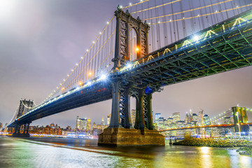 Fototapeta premium Amazing night view of Manhattan and Brooklyn Bridge at night, winter season, New York City
