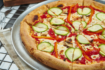 Pizza with a large number of toppings: asparagus, bell pepper, onion, corn, broccoli and cheese. Pizza in composition with ingredients on a black background. Vegetarian food