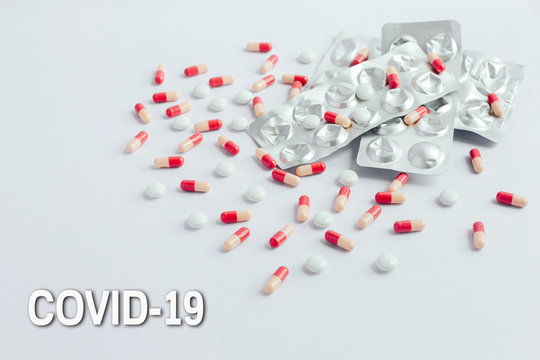 Pills all over a white plane
