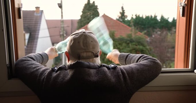old man cheers and support from window apartment after victory