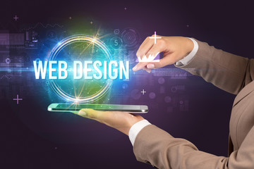 Close-up of a touchscreen with WEB DESIGN inscription, new technology concept