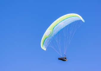 A lone paraglider in sky