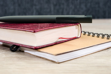 notebook, book and pen on the table. Close-up.