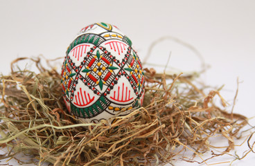 Traditional painted handmade Easter egg on hay