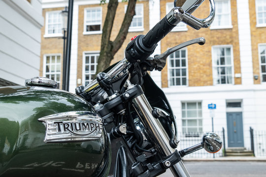 Triumph motorcycle logo with attractive residential street background