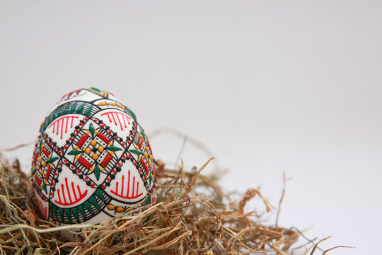 Traditional painted handmade Easter egg on hay