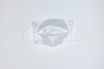 A clean white medical mask on white background. Stop the pandemic of coronavirus
