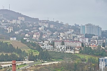 mountain city panorama in fog and rain