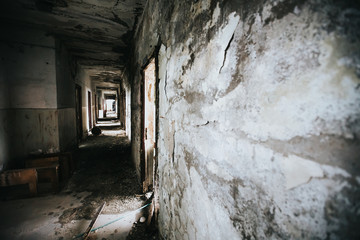 Fototapeta na wymiar Abandoned building corridors with an eerie atmosphere. Dark tourism concept image. 