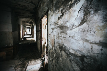 Fototapeta na wymiar Abandoned building corridors with an eerie atmosphere. Dark tourism concept image. 