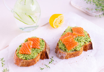 Two crispy toasts with avocado and salted salmon