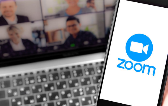 Zoom logo on the screen smartphone and notebook background closeup. Zoom Video Communications is a company that provides remote conferencing services. Moscow, Russia - April 1, 2020