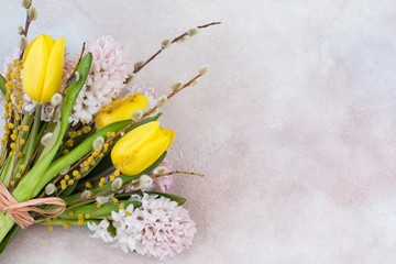 Bouquet of yellow tulips and pink hyacinths, willow and mimosa