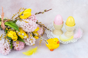 a bouquet of hyacinths and tulips, a chicken and two eggs
