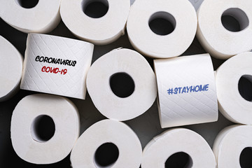 toilet paper rolls with message COVID-19 and #STAYATHOME
