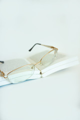 Glasses lying on the books.