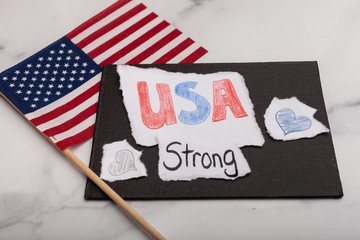 Fototapeta na wymiar USA strong encouraging message with an American flag in the background hand-drawn hearts patriotic background 