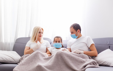 Obraz premium Ill family sitting on sofa at home