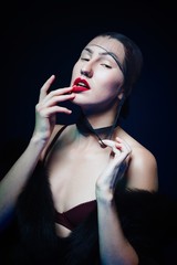 Obraz premium portrait of seductive young woman with stockings on her head against dark background