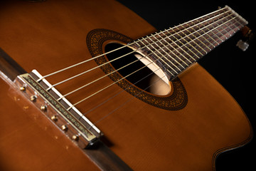 Obraz premium beautiful six-string guitar in perspective on a dark background