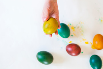 Child painting Easter eggs. Coloring eggs for Easter holiday. child hands holding easter egg....