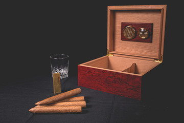 Cigar box on black background and lighter