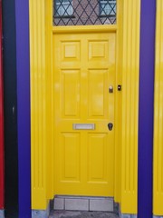 bright sunshine yellow door with navy blue painted walls