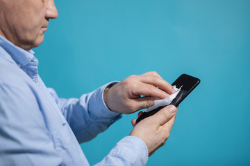 Man disinfects smartphone
