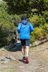 Young man running up the hill. Trial run.