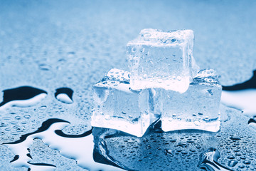 Pyramid of beautiful thawed ice cubes with drops of water
