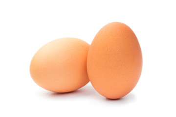 Two fresh brown chicken eggs on a white background