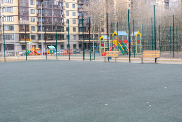 Fototapeta na wymiar Empty playground and football ground in the city's residential block in the quarantine of the coronovirus pandemic