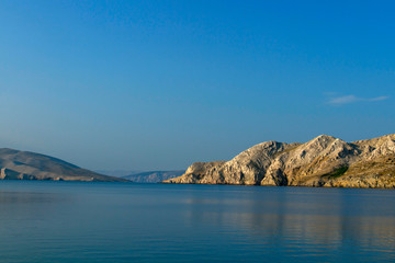 Fototapeta na wymiar Croatian beach at a sunny morning. Island Krk. Adriatic coast. Europe. Summer vacation. Relaxation Concept. Beaches of Croatia.