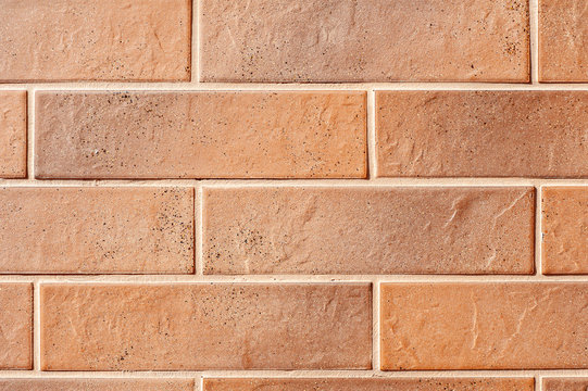 Wall of brown plates with fuga texture bricks.