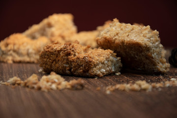 Closeup of home-baked oat crunchies, on wooden board, kitchen baking