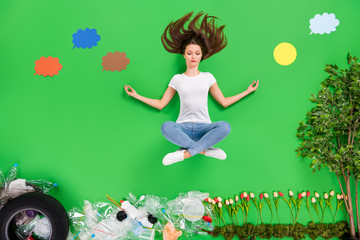 Full length high angle flat lay photo focused lady balancing yoga dream nature planet saving plastic products trash on street anti pollution community owner isolated green color background